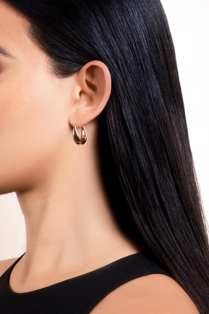 woman showcasing Don Roberto Jeweler's gold hoops