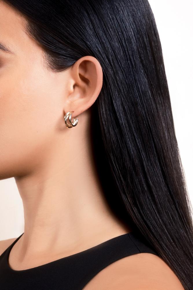 woman showcasing Don Roberto Jeweler's gold earrings
