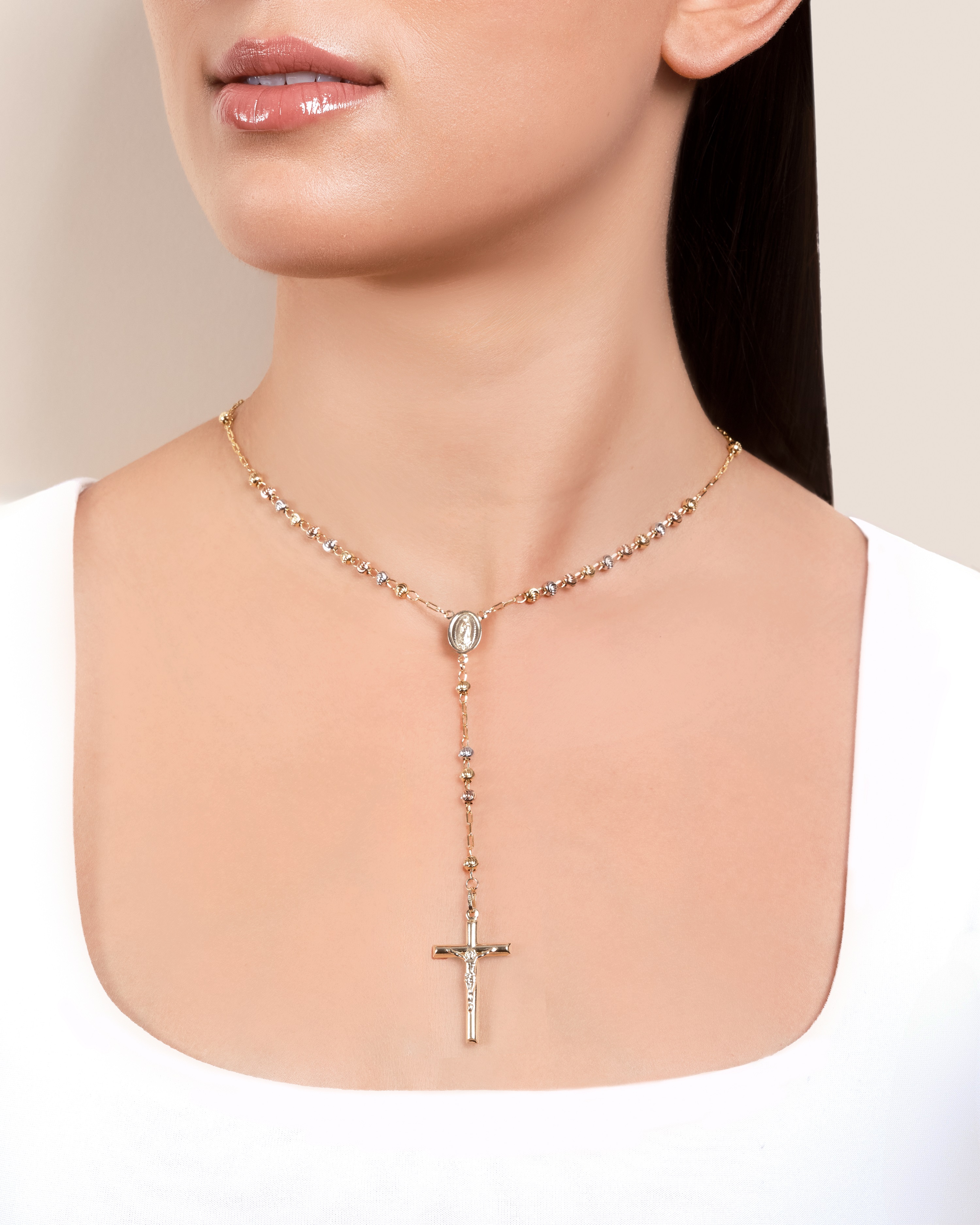 woman showcasing Don Roberto Jeweler's religious necklace with a cross pendant 