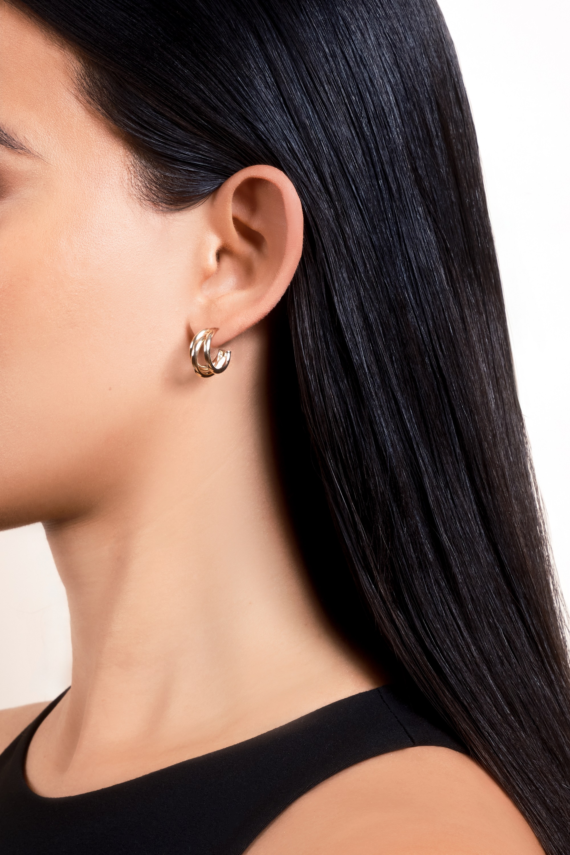 woman showcasing Don Roberto Jeweler's gold earrings